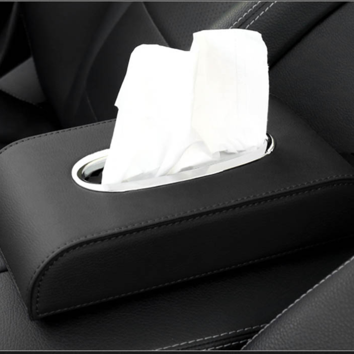 Close-up of the black leather car tissue box cover with a tissue pulled through the oval opening
