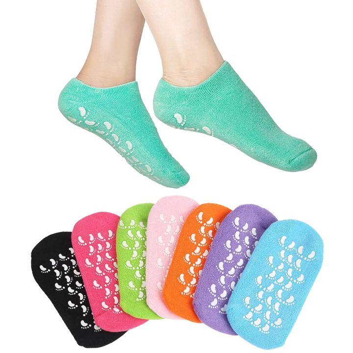 Green silicone gel spa socks worn on feet — low-cut sock form with gel-dot texture, available in multiple colors