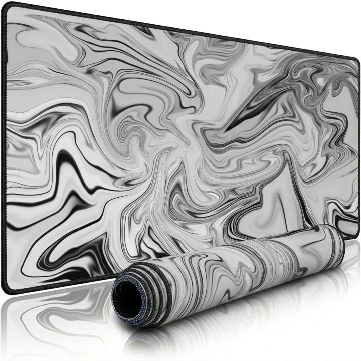 Extra large cloth desk pad with marble swirl design, rolled to show flexibility of the 900x400mm mousepad