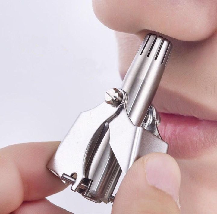 Manual stainless steel nose hair trimmer in use — rounded cutter head gently trims nose hair