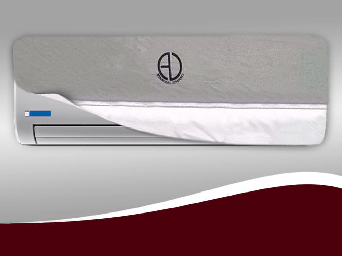 Silver non-woven waterproof cover fitted snugly over a wall-mounted indoor split AC unit