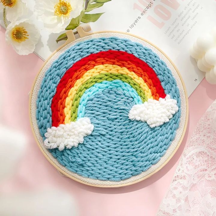 Rainbow embroidery hoop with yarn skeins close-up