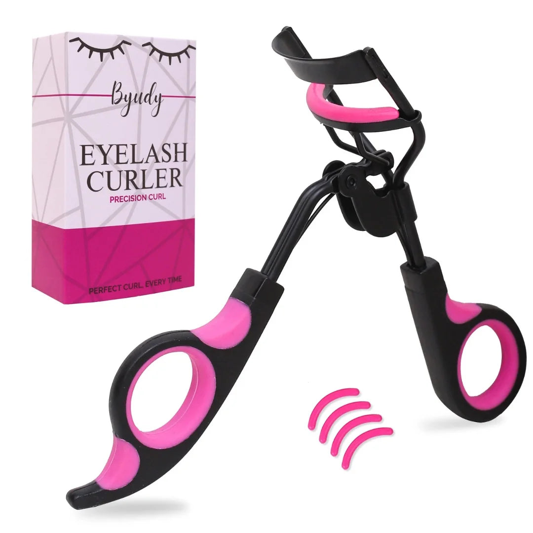 Professional eyelash curler — angled product shot of the black and pink mechanical curler with retail box and silicone replacement pads