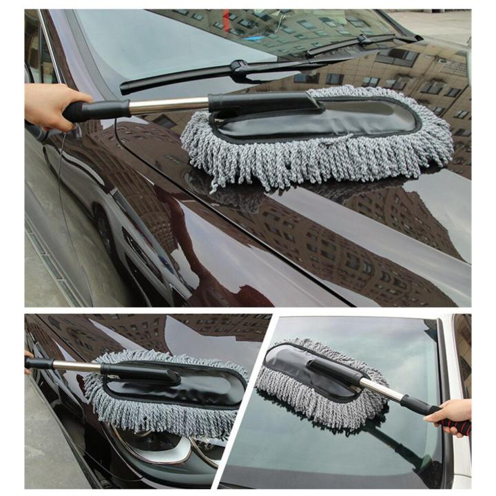 Telescopic car duster in use on a car hood — grey microfiber chenille head gliding over glossy paint without scratching