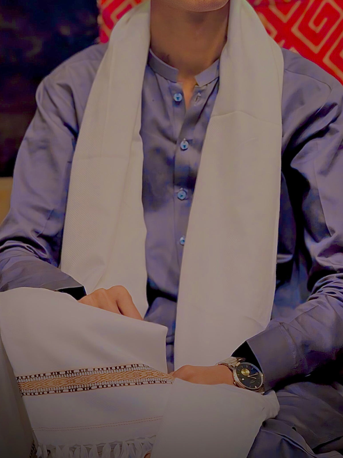 White woolen shawl worn over a shalwar kameez — woven border band and fringed ends on display