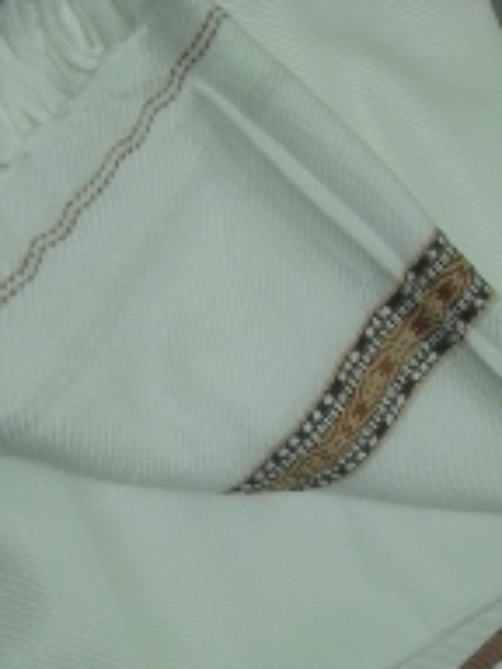 Close-up of the soft white woolen fabric with the decorative woven border stripe