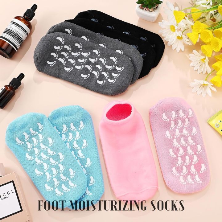 Foot moisturizing socks flat-lay — grey, black, blue and pink pairs with natural essential oils for heel care