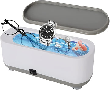 Ultrasonic jewelry cleaner white oval tank with lid on table