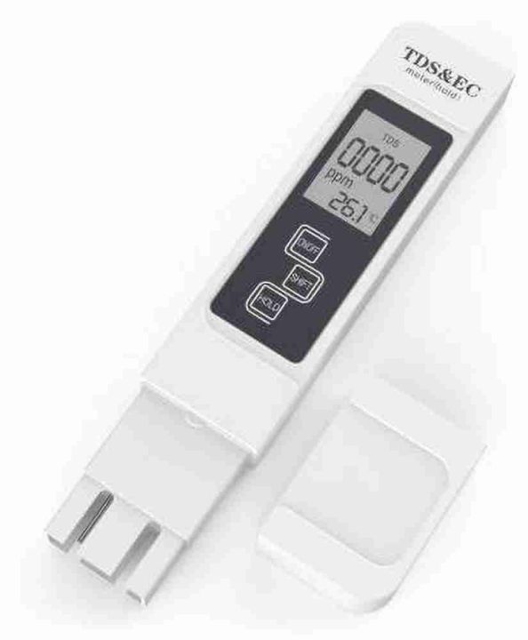 TDS water tester pen dipped in a glass of water measuring purity in PPM