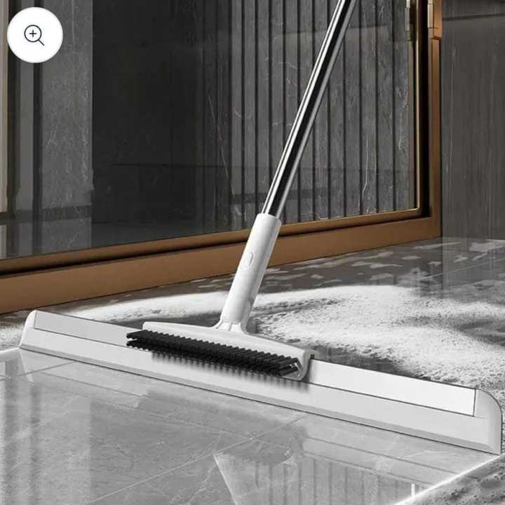 Silicone broom collecting pet hair and dust from a hard floor
