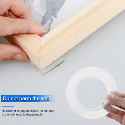 Nano double-sided tape application — hands applying the transparent tape roll to a wall, do-not-harm-the-wall traceless removal