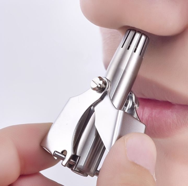 Manual nose trimmer in use at the nostril — pain-free squeeze-handle rotary blades