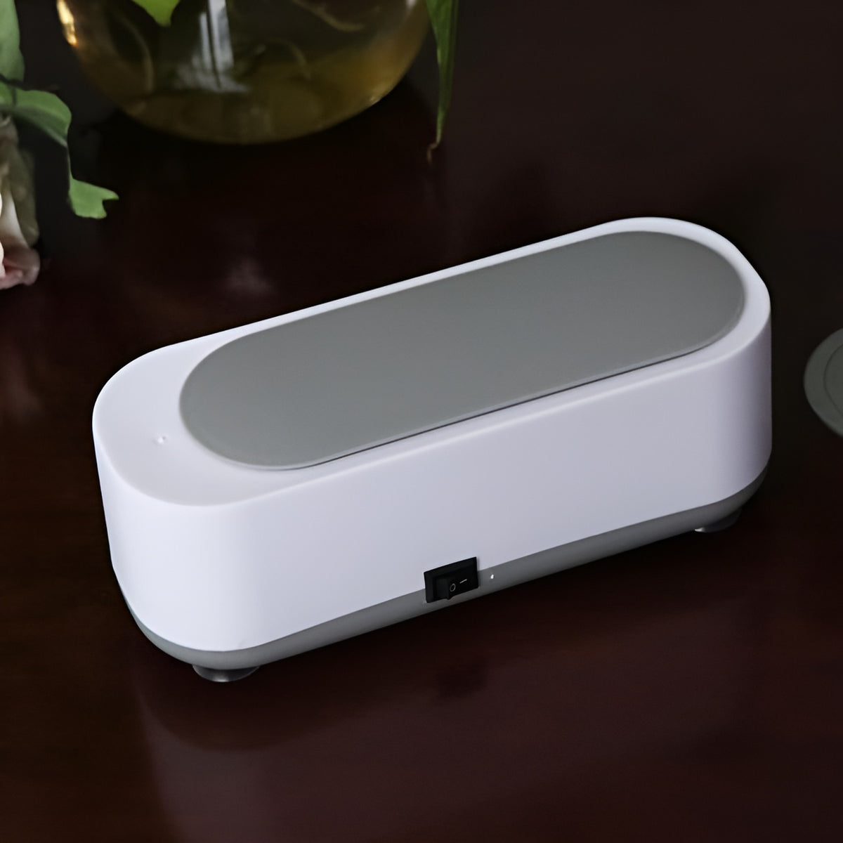 Jewelry cleaner in use with glasses and watches sparkling clean